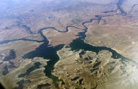 FILE - An aerial view of Lake Powell on the Colorado River along the Arizona-Utah border on Sept. 11, 2019. The U.S. Bureau of Reclamation is expected to publish hydrology projections on Tuesday, Aug. 16, 2022, that will trigger agreed-upon cuts to states that rely on the river. (AP Photo/John Antczak, FIle )