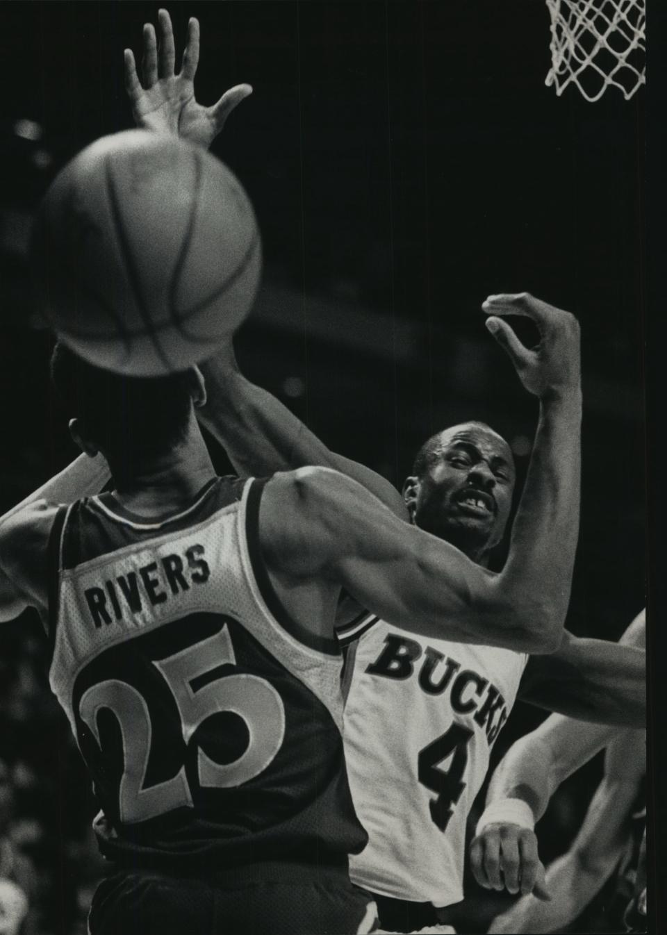 Atlanta's Doc Rivers and Milwaukee's Sidney Moncrief reach for a loose ball in Game 4 of the Hawks-Bucks series in 1989 at the Bradley Center.