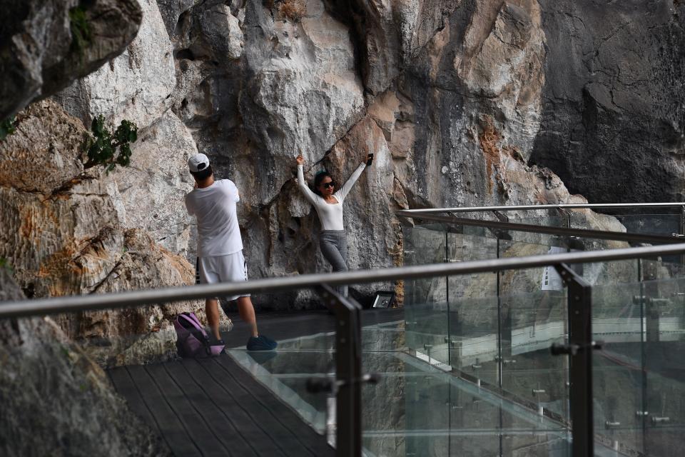 people stand on the Bach Long glass bridge in the Moc Chau district in Vietnam's Son La province