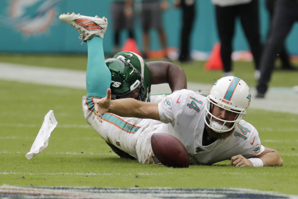 New York Jets outside linebacker Jordan Jenkins, back, sacks Miami Dolphins quarterback Ryan Fitzpatrick (14) during the second half of an NFL football game, Sunday, Nov. 3, 2019, in Miami Gardens, Fla. (AP Photo/Lynne Sladky)