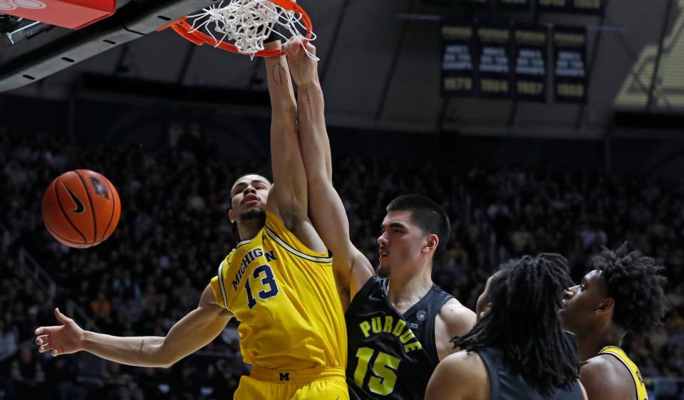 Purdue Boilermakers center Zach Edey (15) dunks the ball over Michigan Wolverines forward Olivier Nkamhoua (13) during the NCAA men’s basketball game, Tuesday, Jan. 23, 2024, at Mackey Arena in West Lafayette, Ind. Purdue Boilermakers won 99-67.