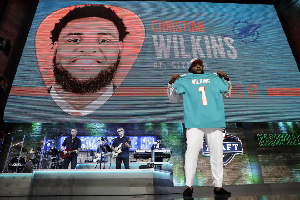 Clemson defensive tackle Christian Wilkins poses with his new jersey after the Miami Dolphins selected Wilkins in the first round at the NFL football draft, Thursday, April 25, 2019, in Nashville, Tenn. (AP Photo/Mark Humphrey)