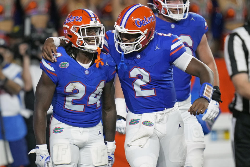 Florida running back Ja'Kobi Jackson (24) celebrates with quarterback DJ Lagway (2) after scoring a touchdown against Central Florida on a 1-yard run during the first half of an NCAA college football game, Saturday, Oct. 5, 2024, in Gainesville, Fla. (AP Photo/John Raoux)