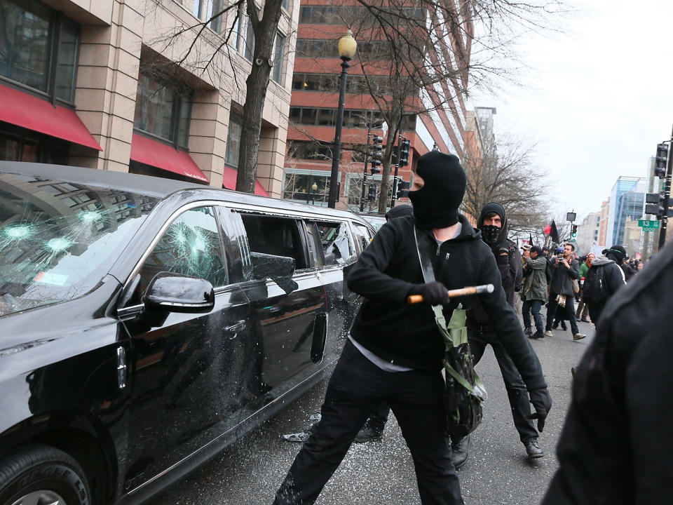 Anti-facist protestors smash the windows of a Limousine in Washington DC: Rex