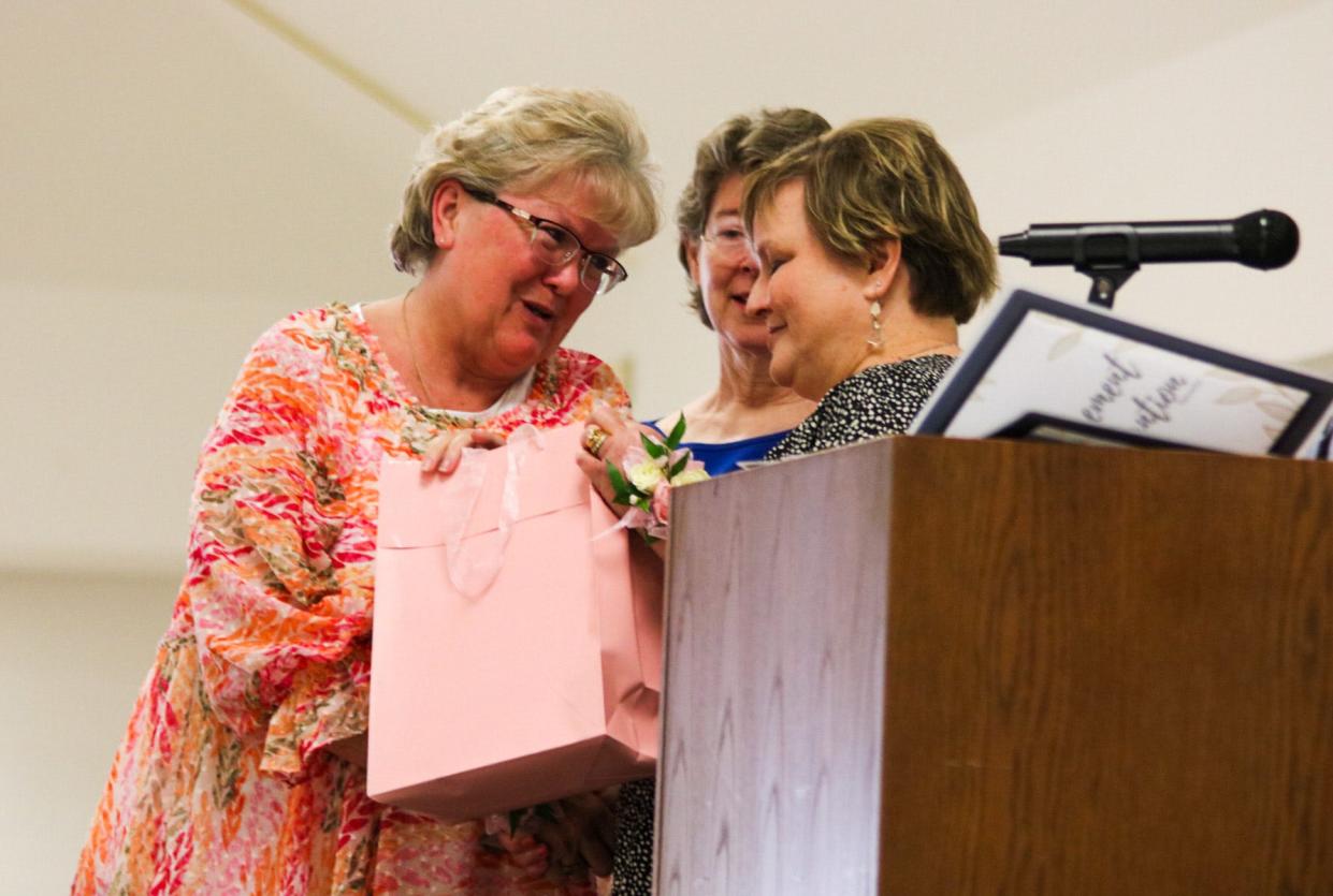 Dawn Brady (left) receives a retirement gift from Superintendent Linn Exline May 7. Brady is retiring after 22 years of service to Salina Public Schools.