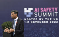 Britain's Prime Minister Rishi Sunak speaks to journalists upon his arrival for the second day of the UK Artificial Intelligence (AI) Safety Summit, at Bletchley Park, in Bletchley, England, Thursday, Nov. 2, 2023. U.S. Vice President Kamala Harris and British Prime Minister Rishi Sunak are set to join delegates Thursday at a U.K. summit focused on containing risks from rapid advances in cutting edge artificial intelligence. (Justin Tallis/Pool Photo via AP)