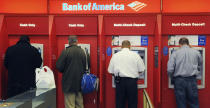 FILE - Customers use ATMs at a Bank of America branch office in Boston, Oct. 16, 2009. The Clearing House Payments Co. said Monday, Nov. 6, 2023, that a technical error on Thursday resulted in some payment information sent to banks with account numbers and customer names masked, preventing them from being processed immediately. (AP Photo/Lisa Poole, File)