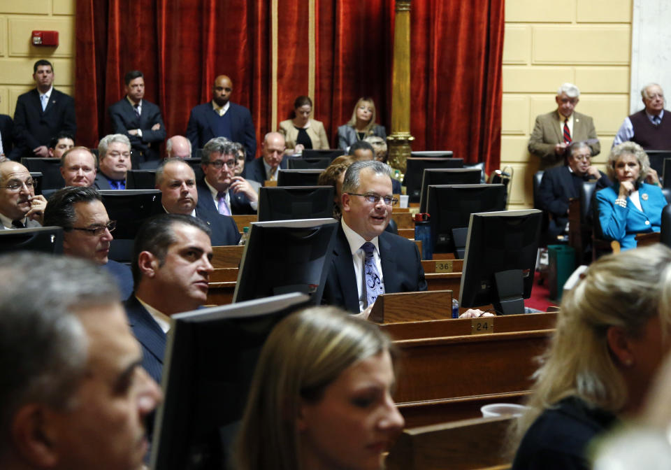 Democrat Nicholas Mattiello, of Cranston, R.I., sits at his seat (middle, blue tie) in the Rhode Island House of Representatives at the Statehouse in Providence, Tuesday, March 25, 2014 during the voting process for a new House Speaker. Mattiello was elected after the abrupt resignation of Gordon Fox, one of the most powerful figures in state government, after his home and Statehouse office were raided as part of a criminal probe. (AP Photo/Elise Amendola)