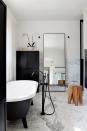 <p>Rather than tucking the bathtub faucet between the window and tub, Hecker Guthrie decided to give it the spotlight by floating it in the center of the room. The edgy matte black finish, luxe marble floors, and neutral colors throughout ensure a polished whole with just a touch of eccentricity. </p>