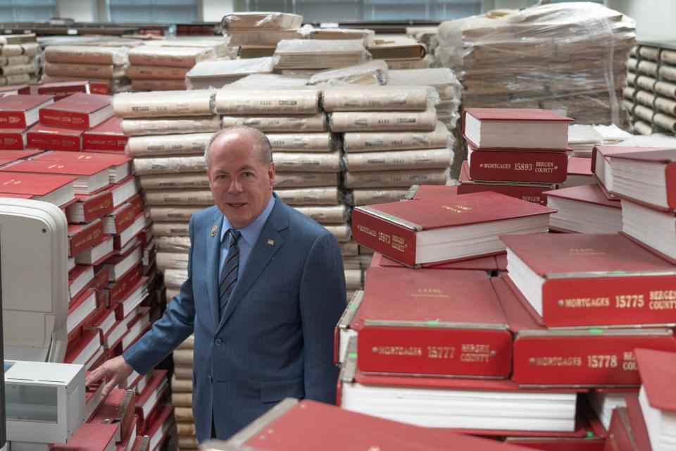 Bergen County Clerk John Hogan stands in stacks of documents which have been digitalized. The documents include deeds and land records dating back to the 1800s which will now be available online.