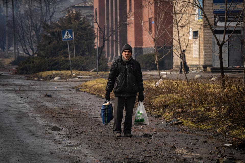 A local resident walks down a street as the sounds of shelling continue in Bakhmut yesterday as Russia’s military invasion targets the key city (AFP via Getty Images)