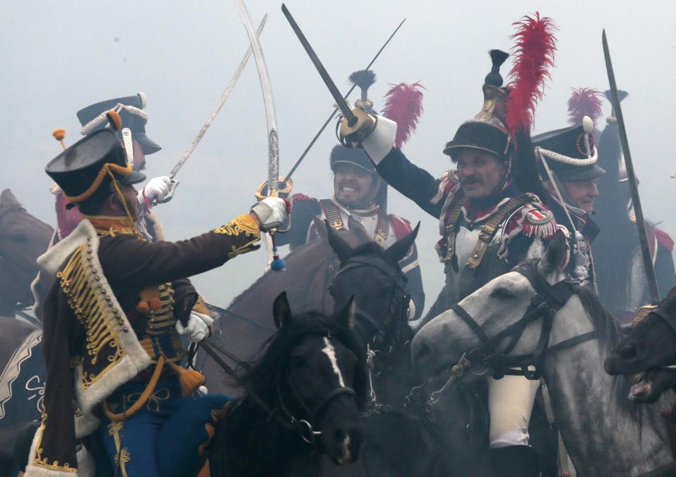 Members of historic clubs wearing 1812-era uniforms take part in a staged battle re-enactment to mark the 200th anniversary of the battle of Borodino, in Borodino, about 110 km (70 miles) west of Moscow, Sunday, Sept. 2, 2012. The Battle of Borodino in 1812 was the largest and bloodiest single-day action of the French invasion of Russia. (AP Photo/Mikhail Metzel)