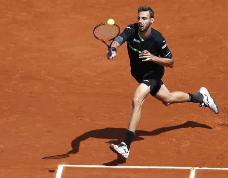 Marcel Granollers of Spain plays a shot to Roger Federer of Switzerland during their men's singles match at the French Open tennis tournament at the Roland Garros stadium in Paris, France, May 27, 2015. REUTERS/Vincent Kessler