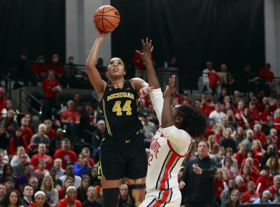 Michigan forward Cameron Williams, left, shoots in over Ohio State forward Eboni Walker during the first half of an NCAA college basketball game in Columbus, Ohio, Saturday, Dec. 31, 2022. (AP Photo/Paul Vernon)