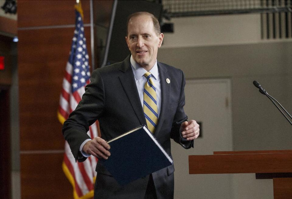 House Ways and Means Committee Chairman Rep. Dave Camp, R-Mich., the House tax writer, leaves the podium after a news conference on Capitol Hill in Washington, Wednesday, Feb. 26, 2014, where he outlined a major plan to rewrite the nation’s tax code. The plan has almost no chance of becoming law this year says Senate Republican leader Mitch McConnell, and even House Speaker John Boehner, R-Ohio, distanced himself from the details earlier in the day. (AP Photo/J. Scott Applewhite)