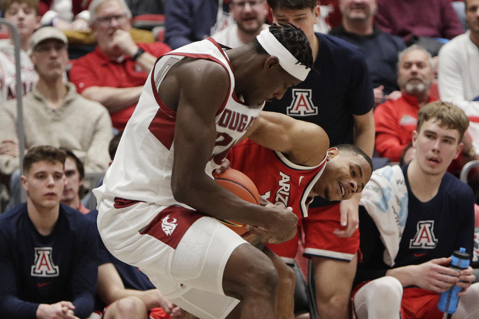 Washington State center Rueben Chinyelu, front left, and Arizona forward Keshad Johnson, front right, vie for the ball during the first half of an NCAA college basketball game, Saturday, Jan. 13, 2024, in Pullman, Wash. (AP Photo/Young Kwak)