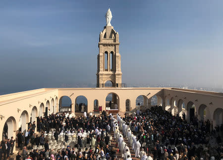 Faithful attend the beatification ceremony for seven monks and twelve clergy, who were killed in Algeria’s civil war, at the Notre Dame de Santa Cruz in the city of Oran, Algeria December 8, 2018. REUTERS/Abdelaziz Boumzar