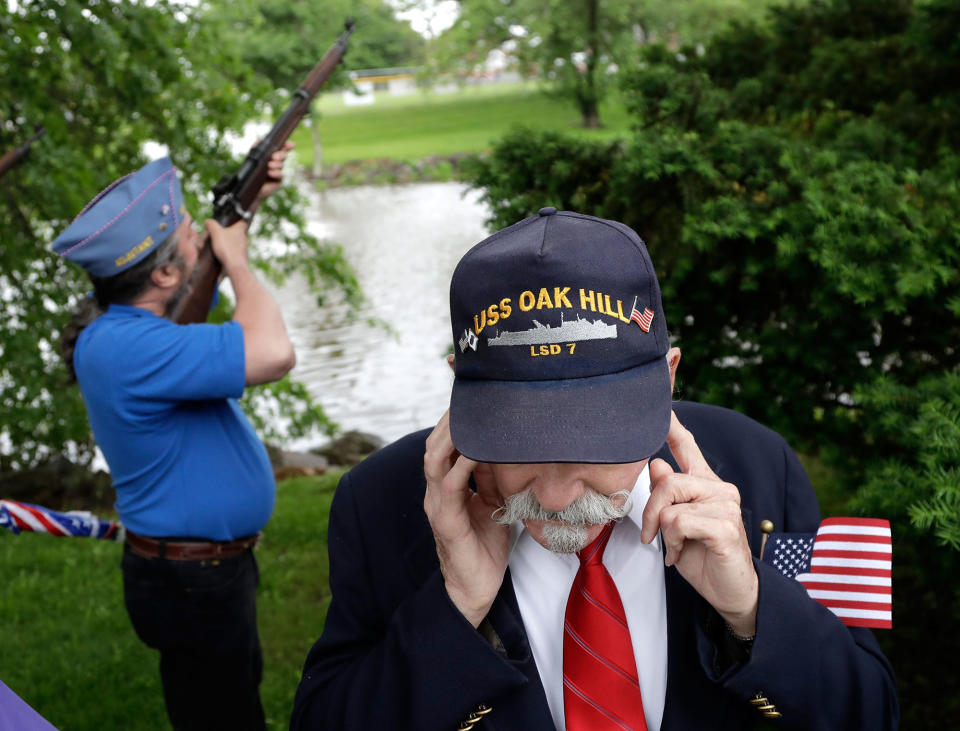 <p>Jim Benning, right, who served as a second class machinist’s mate on the USS Oak Hill during the Vietnam War, covers his ears as Chris Moeller, back, of the Sons of the American Legion, takes part of a gun salute during a Memorial Day observance, Monday, May 29, 2017, in Bridgewater, N.J. (Photo: Julio Cortez/AP) </p>