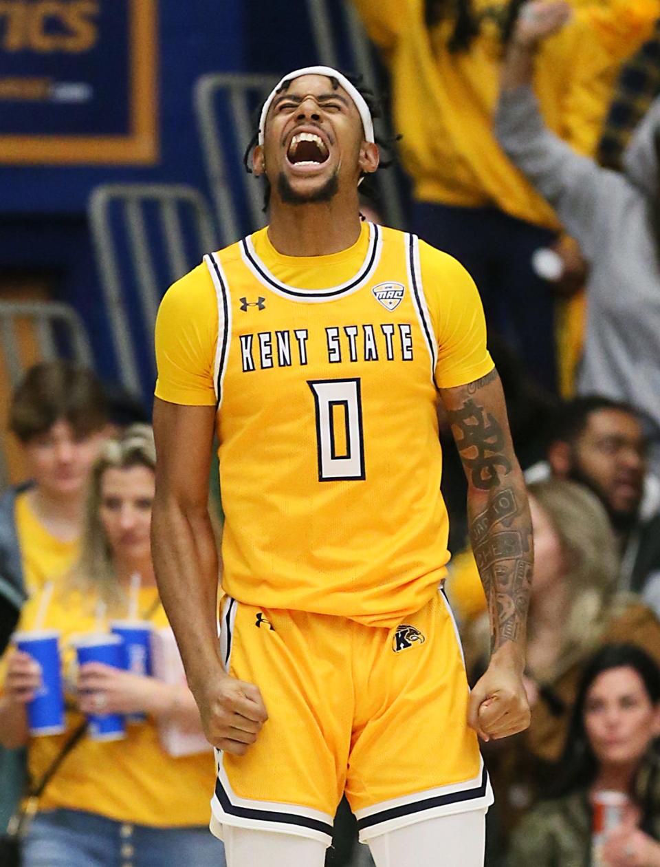 Kent State's Julius Rollins celebrates hitting a 3-pointer against Akron at the M.A.C. Center in Kent on Friday.