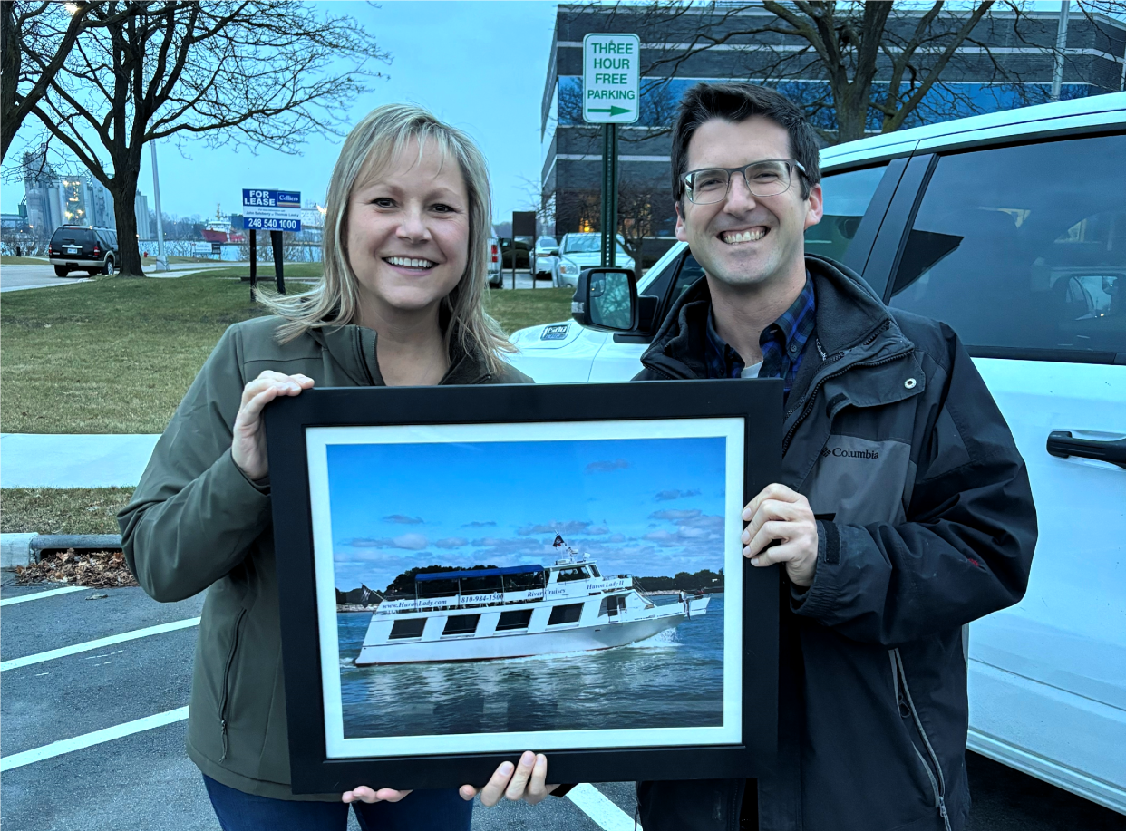 Jenny Ciolek, former owner of the Huron Lady II, and Dustin Walker, the new owner, celebrate the transition of the business early this year.