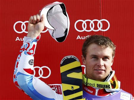 Alexis Pinturault of France celebrates on the winners podium after the men's World Cup slalom ski race in Wengen January 19, 2014. REUTERS/Ruben Sprich