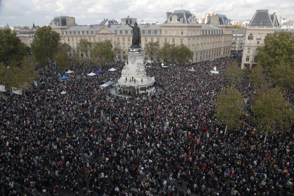 Hundreds of people gather on Republique square during a demonstration Sunday Oct. 18, 2020 in Paris. Demonstrations around France have been called in support of freedom of speech and to pay tribute to a French history teacher who was beheaded near Paris after discussing caricatures of Islam's Prophet Muhammad with his class. Samuel Paty was beheaded on Friday by a 18-year-old Moscow-born Chechen refugee who was shot dead by police. (AP Photo/Michel Euler)