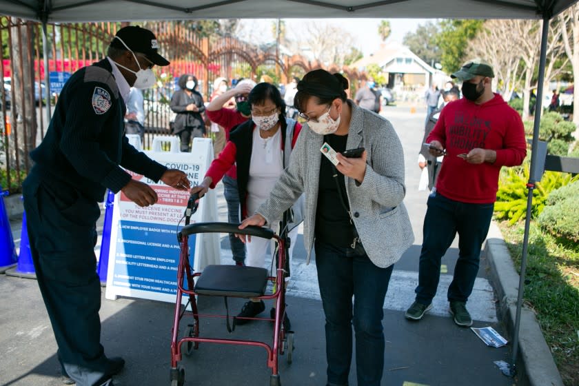 LOS ANGELES, CA - FEBRUARY 11: Hundreds of people line up for their turn at receiving the COVID-19 vaccine at Kedren Health on Thursday, Feb. 11, 2021 in Los Angeles, CA. (Jason Armond / Los Angeles Times)