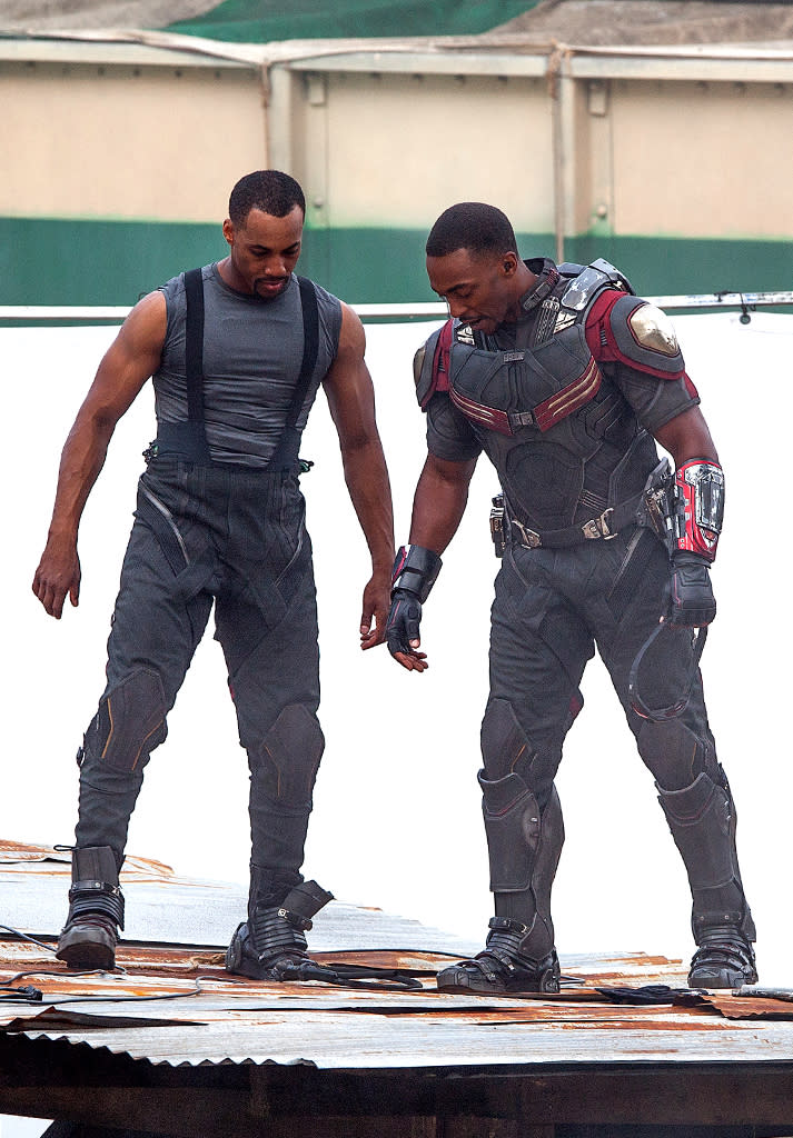 Before he can take wing, Falcon (sans CGI wings) huddles with his stunt double during filming of action sequence on May 15.