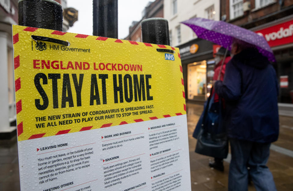 People walk past a Government sign warning people to stay at home on the High street in Winchester, Hampshire, during England's third national lockdown to curb the spread of coronavirus. Picture date: Wednesday January 20, 2021. (Photo by Andrew Matthews/PA Images via Getty Images)