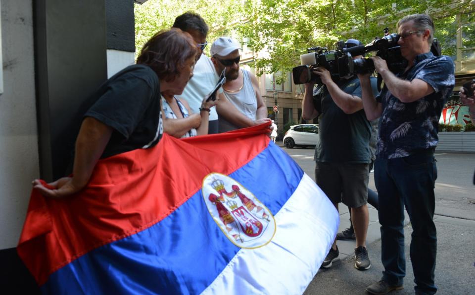 Supporters of tennis star Novak Djokovic wait outside Federal Court of Australia as Novak Djokovic loses chance to play at Australian Open - Getty Images