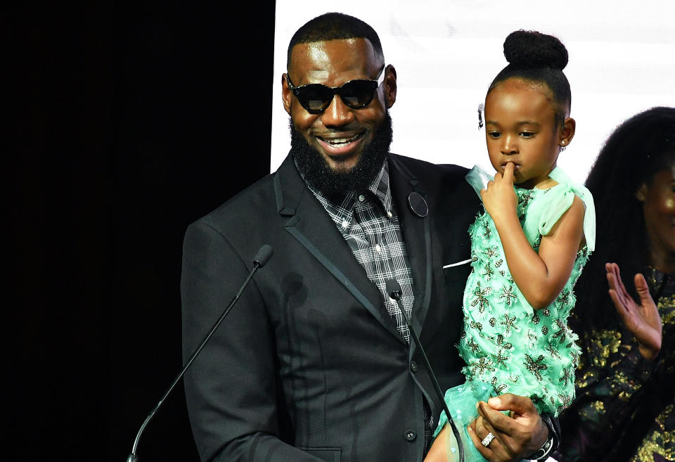 LeBron James, pictured with his daughter, Zhuri, is being dad shamed for not buckling her into a car seat. (Photo: Getty Images)