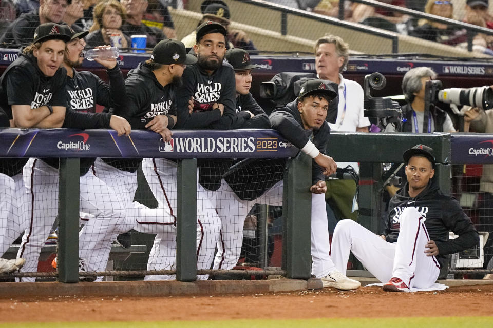 Members of the Arizona Diamondbacks watch during the third inning in Game 4 of the baseball World Series against the Texas Rangers Tuesday, Oct. 31, 2023, in Phoenix. (AP Photo/Brynn Anderson)