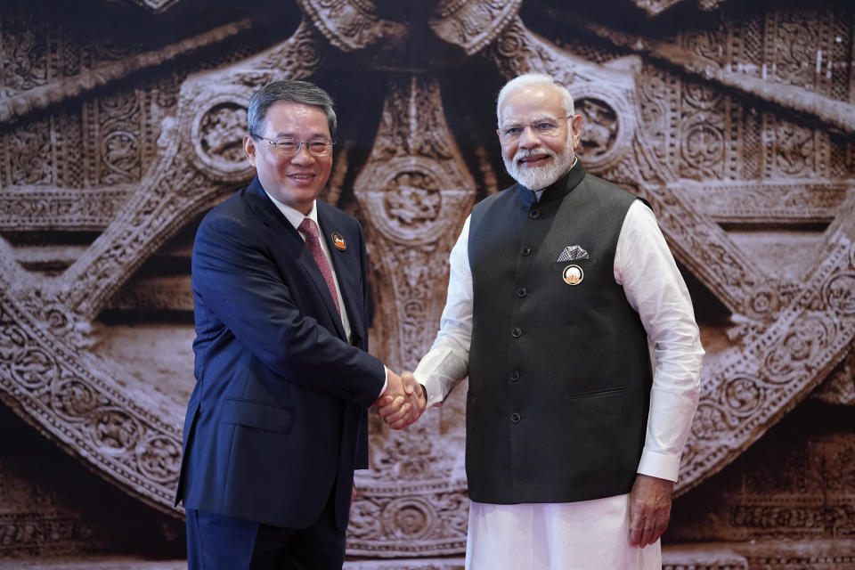 Indian Prime Minister Narendra Modi, right, shakes hand with Chinese Premier Li Qiang upon his arrival at Bharat Mandapam convention centre for the G20 Summit in New Delhi, India, Saturday, Sept. 9, 2023. (AP Photo/Evan Vucci, Pool)