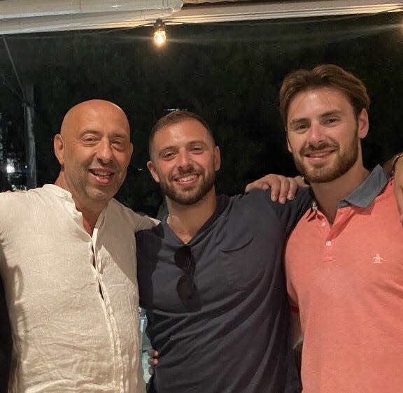 George Papas (right), who scored his 1,000th point at Monmouth recently, with his father, Stefanos Papathanasiou (left), and brother, Tommy, who currently plays in Greece.