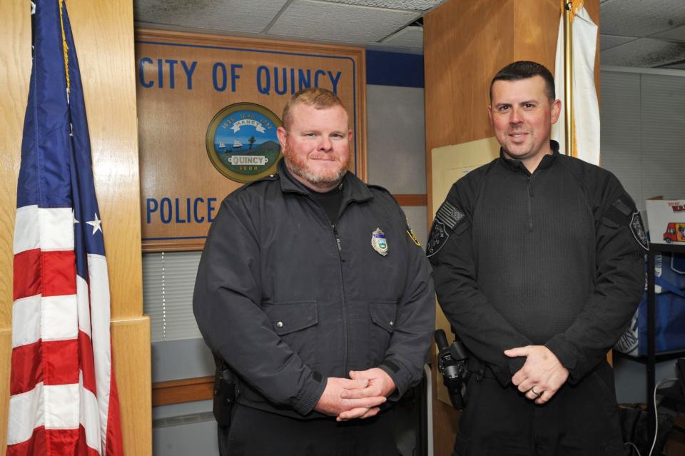 Quincy police officers Michael Brokmeier, left, and Sean Fitzgerald, right, received commendations from the Quincy Police Department for rescuing a man from his burning home.