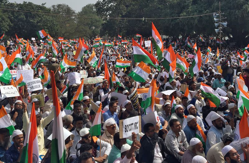 Demonstrators carrying India's national flags shout slogans during a protest rally against a new citizenship law, in Bengaluru