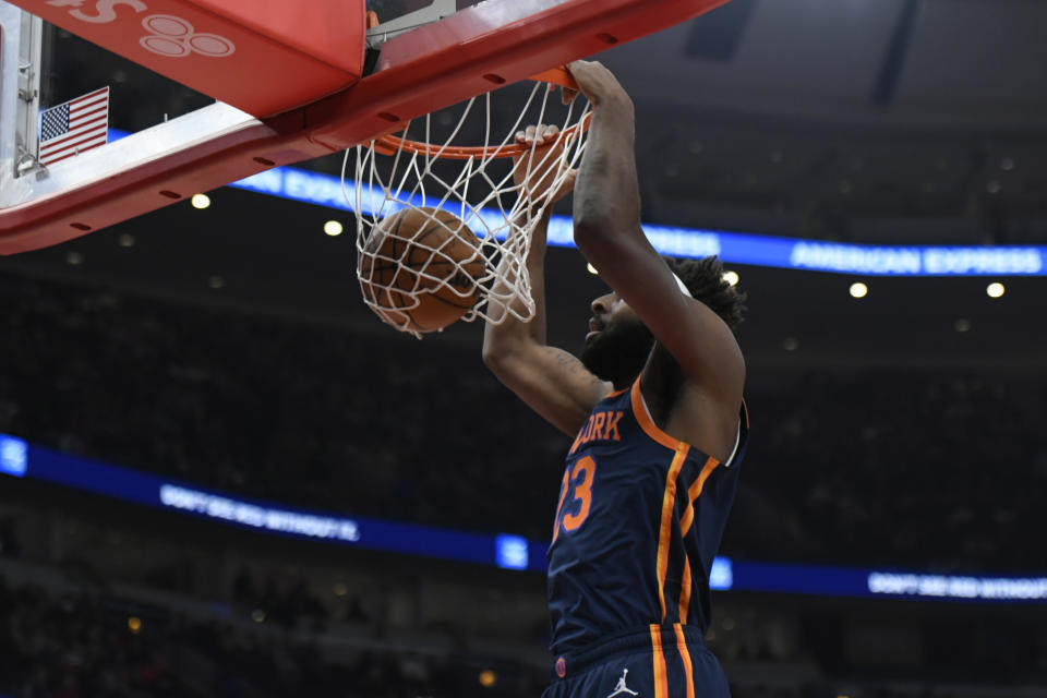 New York Knicks' Mitchell Robinson (23) dunks during the first half of an NBA basketball game against the Chicago Bulls, Friday, Dec. 16, 2022, in Chicago. (AP Photo/Paul Beaty)