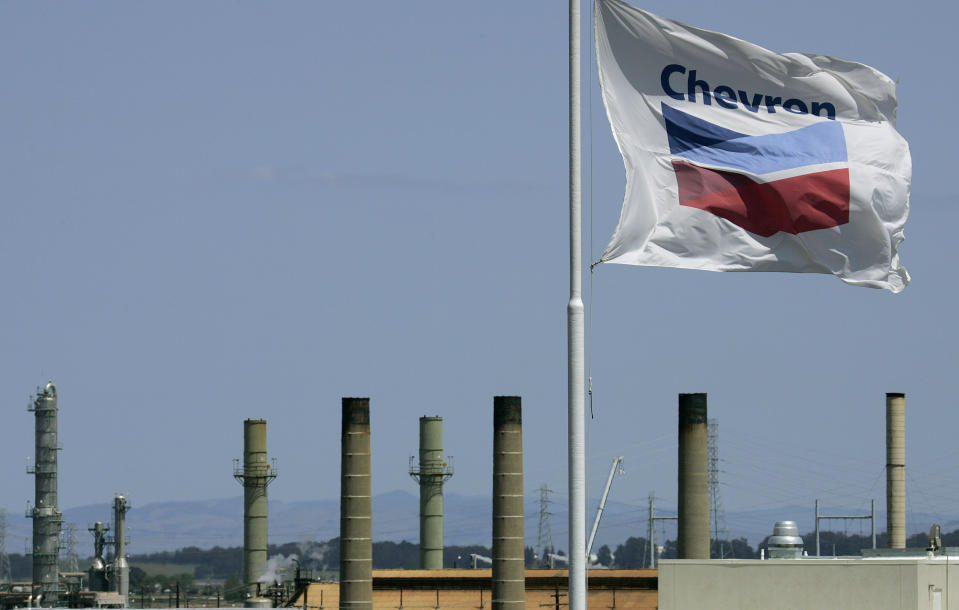 FILE - This April 21, 2008 file photo shows a Chevron flag flying over the Chevron refinery in Richmond, Calif. Chevron Corp. is facing millions of dollars in additional taxes for its refinery in Richmond after an appeals board ruled that the refinery was worth more than the county's assessment. (AP Photo/Ben Margot)