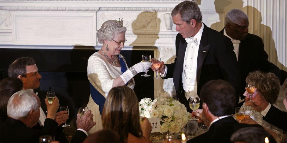 <p>The queen and President George W. Bush toasted their glasses at a white-tie state dinner held at the White House. </p>