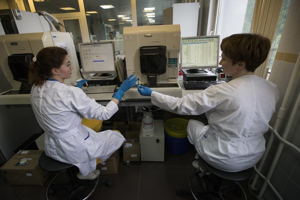 FILE - In this May 24, 2016 file photo, employees work in Russia's national drug-testing laboratory in Moscow, Russia. Russia is accused of manipulating an archive of doping data from a laboratory in Moscow, which was meant to be a peace offering to the World Anti-Doping Agency to solve earlier disputes. (AP Photo/Alexander Zemlianichenko, File)