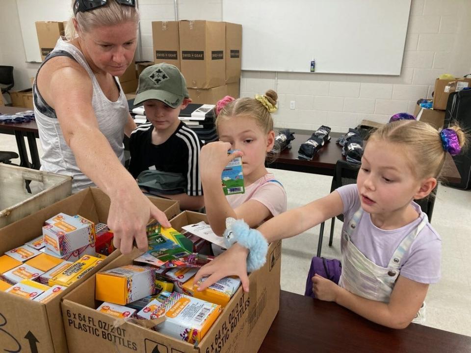 Children check out school supplies Saturday at the National Guard Armory in West Palm Beach during Operation Homefront's school supplies giveaway.