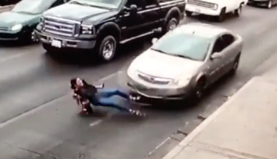 The woman slid under the car after running across the road. Source: CEN