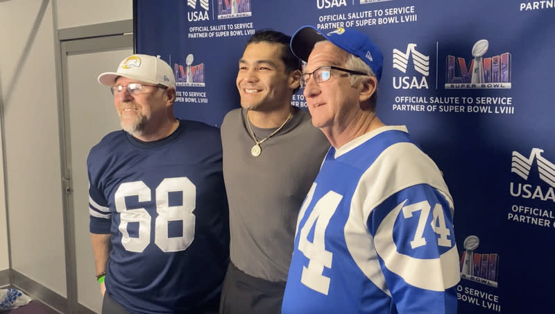 Los Angeles Rams wide receiver Puka Nacua, center, poses for a photo with Rams fans Michael Grabow, left, and Jim Sullivan, right, at the USAA lounge inside the Super Bowl Experience at the Mandalay Bay Convention Center in Las Vegas on Saturday, Feb. 10, 2024. Sullivan, an Air Force veteran, was gifted a trip to the Super Bowl through USAA and brought Grabow, also an Air Force veteran, with him to attend the Super Bowl.