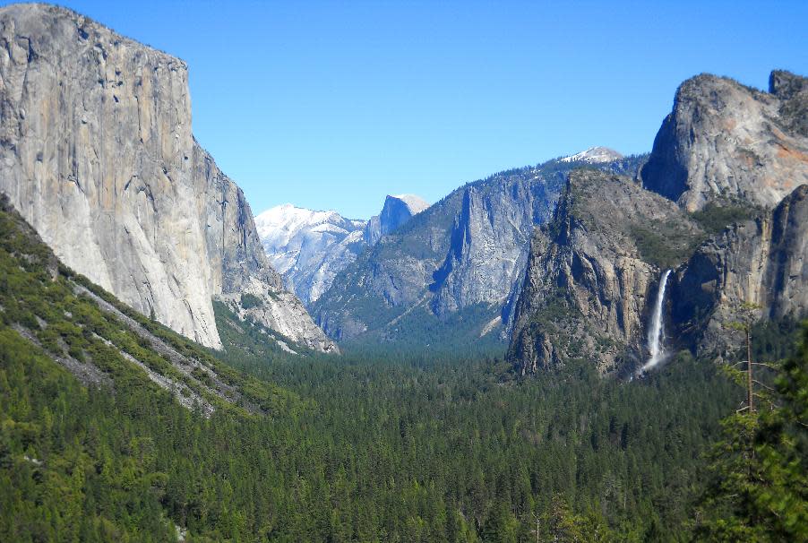 This April 2013 image shows Yosemite Valley as seen from Tunnel View with three of Yosemite National Park's best-known natural attractions: The El Capitan summit on the left, the granite peak known as Half Dome in the distant center, and Bridalveil Fall on the right. The park, in California, is one of the nation's most-visited national parks. (AP Photo/Kathy Matheson)