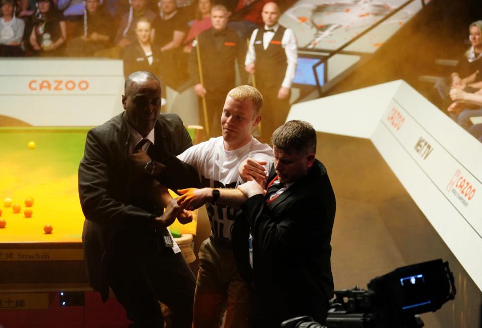 Whittingham escorted out by security at the Crucible (PA)