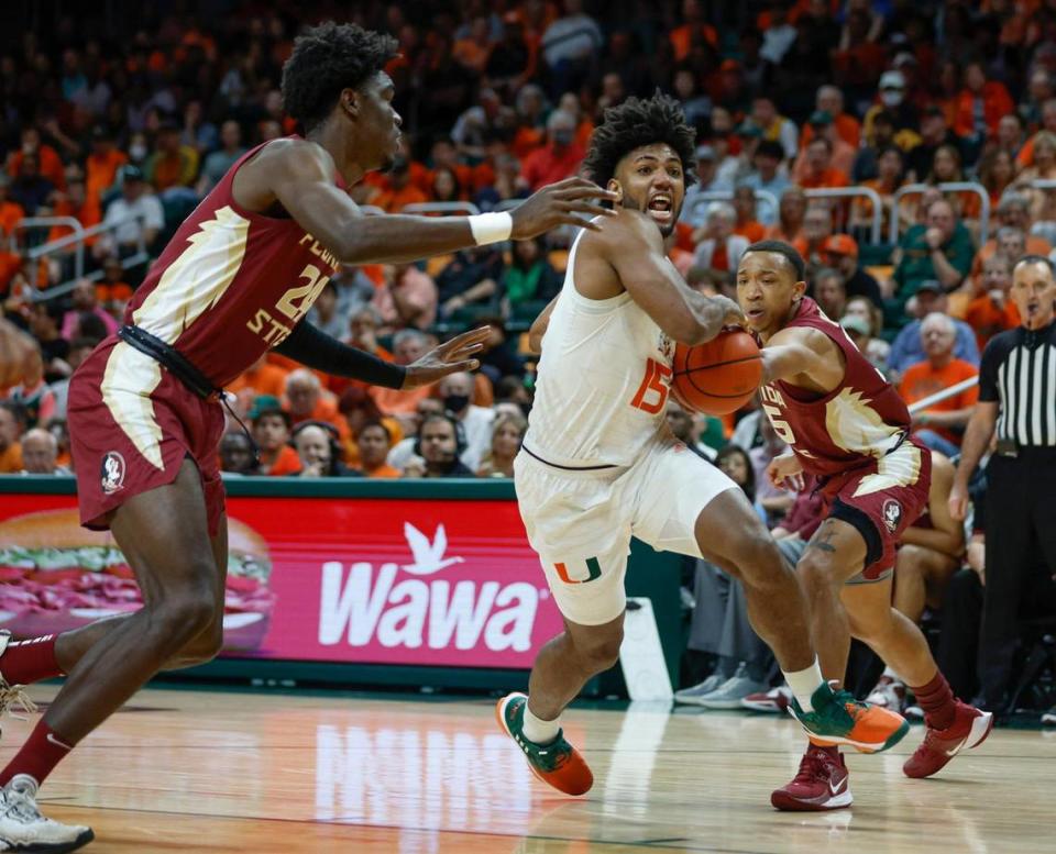 Miami Hurricanes forward Norchad Omier (15) drives the ball to the basket as Florida State Seminoles center Naheem McLeod (24) defends in the first half at the Watsco Center in Coral Gables, Florida on Saturday, February 25, 2023.