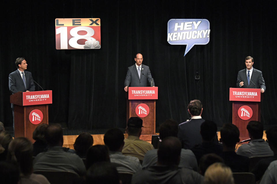 FILE - In this Wednesday, April 24, 2019, file photo, candidates for Kentucky governor, from left, Democratic former state Auditor Adam Edelen, Kentucky state Rep. Rocky Adkins, D-Sandy Hook, and Democratic Attorney General Andy Beshear stand on stage during a debate at Transylvania University in Lexington, Ky. The three leading Kentucky Democrats on the May primary ballot for governor agree their state badly needs a new chief executive. (AP Photo/Timothy D. Easley, File)