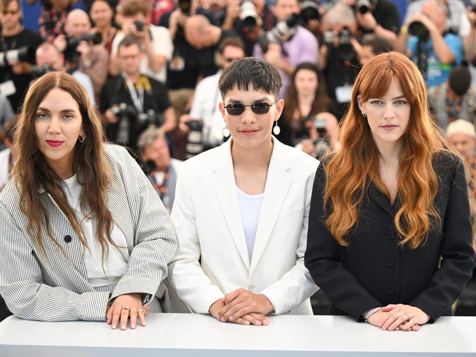 Director Gina Gammell, Ladainian Crazy Thunder and Director Riley Keough attend the photocall for "War Pony" dur ing the 75th annual Cannes film festival at Palais des Festivals on May 21, 2022 in Cannes, France.