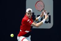 Mar 24, 2019; Miami Gardens, FL, USA; John Isner of the United States hits a backhand against Albert Ramos-Vinolas of Spain (not pictured) in the third round of the Miami Open at Miami Open Tennis Complex. Mandatory Credit: Geoff Burke-USA TODAY Sports