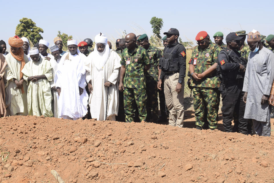 Nigeria Chief of Army Staff Lieutenant General Taoreed Lagbaja, center, with other Community leaders pray at the grave side were victims of an army drones attack were buried in Tudun Biri village Nigeria, Tuesday, Dec. 5, 2023. At least 80 people have been confirmed dead after an army drone attack "mistakenly" bombed a religious gathering in northwest Nigeria, authorities said as the nation's leader ordered Tuesday a probe in the latest of such rampant misfires in Nigeria's conflict zones. (AP Photo Kehinde Gbenga)